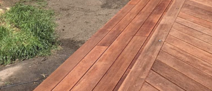 Screen Shot 2021-08-13 at 12.52.39 pm Custom-built wooden deck with modern steps and seating area near a brick house