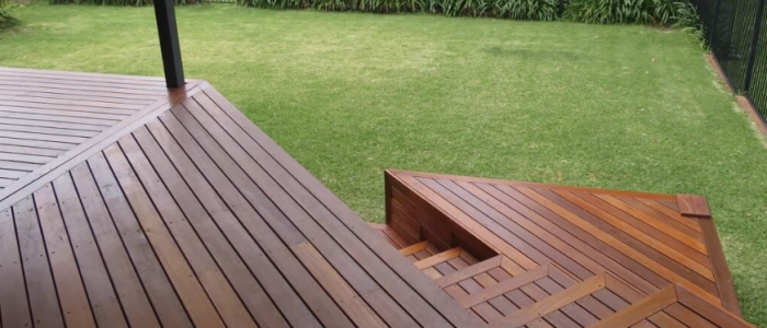 Screen Shot 2023-02-28 at 8.14.01 am Custom-built wooden deck with modern steps and seating area near a brick house