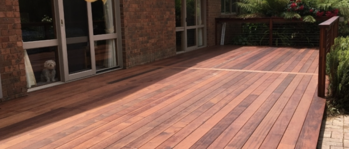 Screen Shot 2023-02-28 at 8.15.45 am Custom-built wooden deck with modern steps and seating area near a brick house